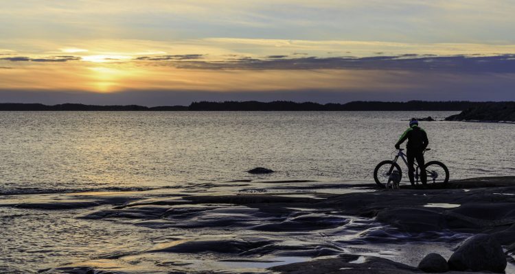 Cyclist admiring the sunset in Kopparnäs