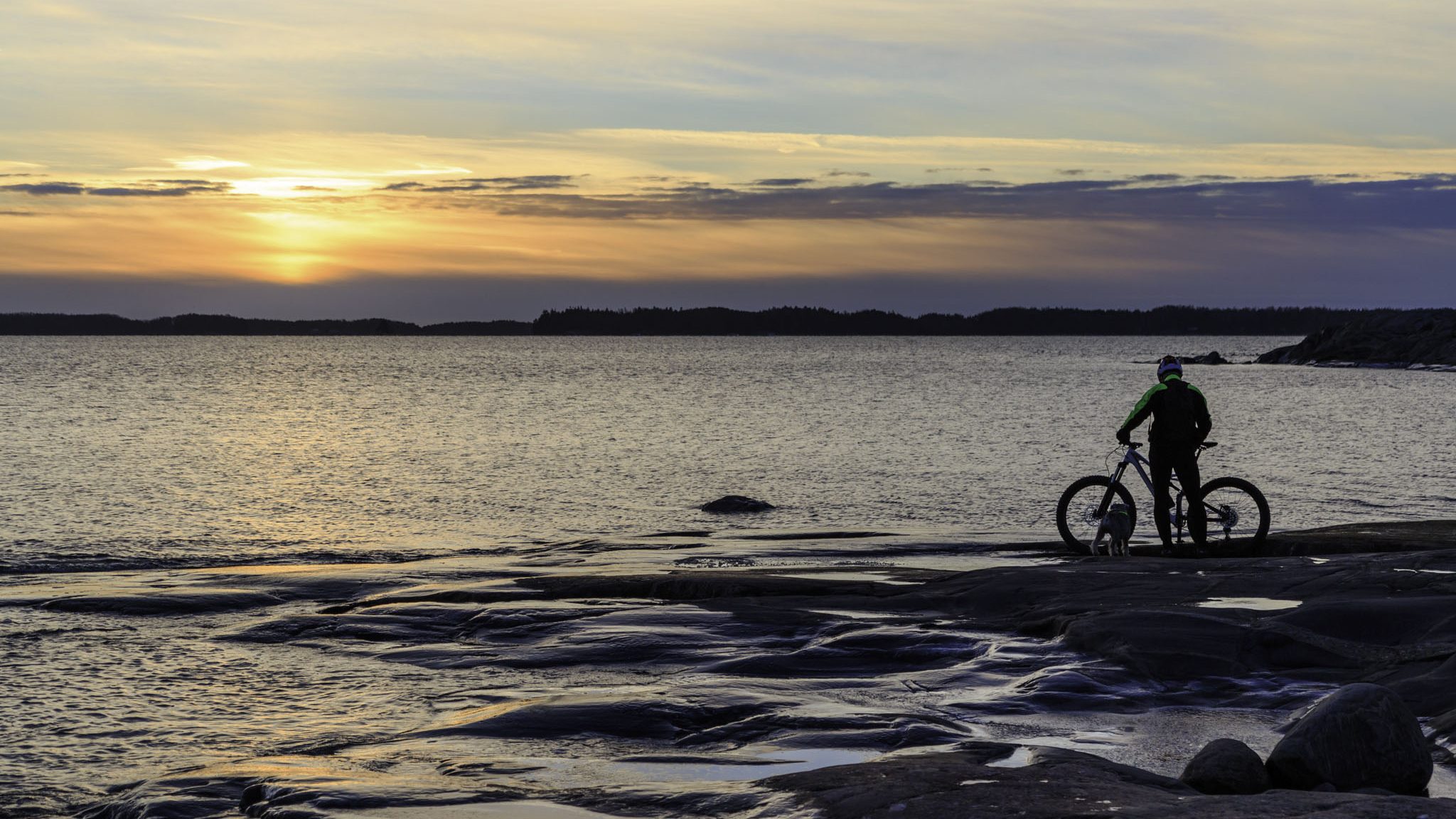 Cyclist admiring the sunset in Kopparnäs