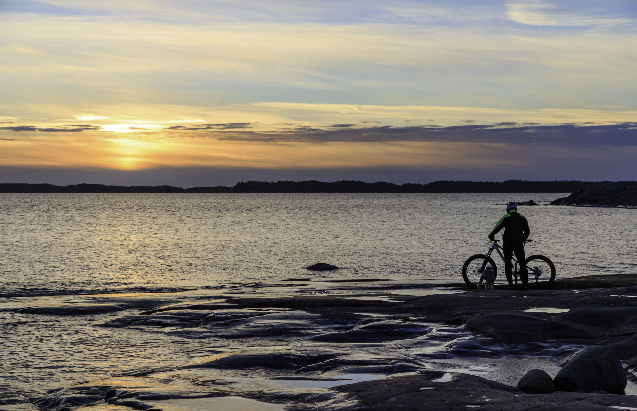 Cyclist admiring the sunset in Kopparnäs