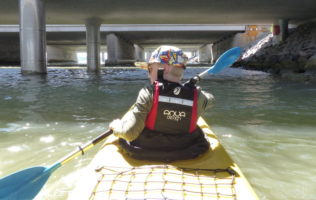 kayaker under the bridge