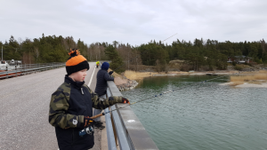 Boys fishing from a bridge