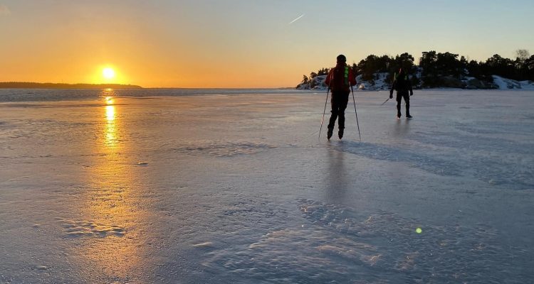 Skaters in winter sunset.