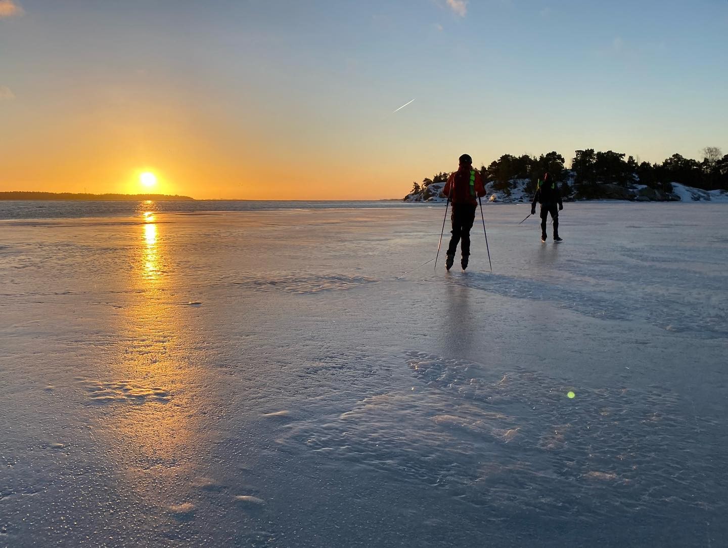 Skaters in winter sunset.